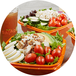 Salad and Go salads in orange bowls and cold iced tea